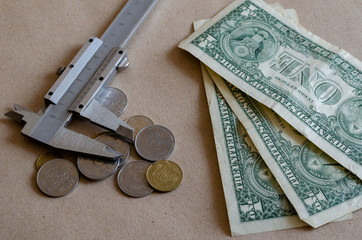 Vernier caliper and small money on the table.