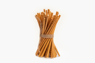 Straw sticks are made of wheat flour on white background
