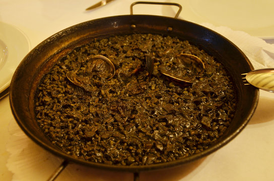 Paella is a Spanish squid ink rice dish originally from Valencia. Seafood paella from a local cafe at Barcelona.