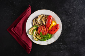 Grilled vegetables with parsley. Grilled eggplant, tomato, red and yellow bell peppers and zucchini.