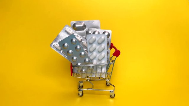 courier in gloves deliver shopping cart with medicine pills isolated. online order from pharmacy or drugstore. safe contact less courier delivery medicine. pharmaceutical business. social distancing