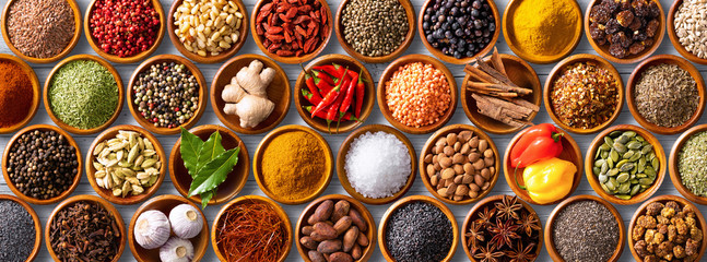 Colourful background from various herbs and spices for cooking in bowls