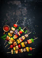 Chicken kebabs on skewers with mushrooms and vegetables