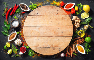 Colourful various herbs and spices for cooking on dark background