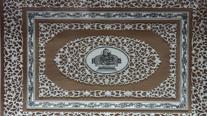 A close up of engraved ceramic on the wall