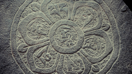 A close up of engraved symbols on stone