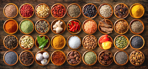 Colourful background from various herbs and spices for cooking in bowls