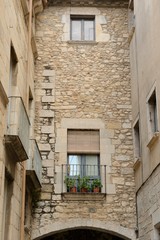 Fototapeta na wymiar Stone facade over arch in Girona, Spain