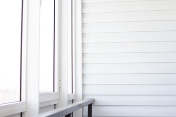 White balcony with railing and light from the window