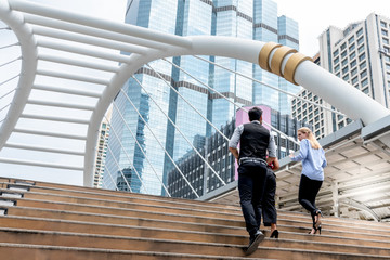 Businessmen team, group Walking up the stairs in the downtown area Full of tall buildings, to business concept.