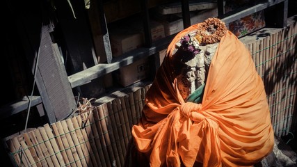 A sculpture stone cover with orange cloth