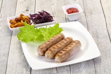 Grilled sausages served mushrooms and cabbage