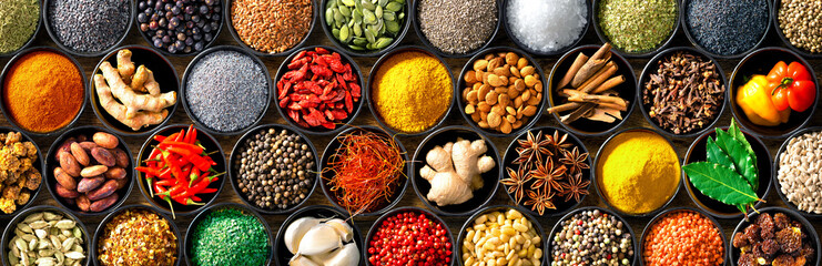 Colourful background from various herbs and spices for cooking in bowls