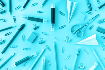 School supplies background in trendy aqua color. Back to school concept. Flat lay. Top view. Backdrop for your design.