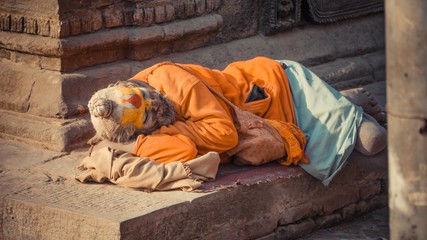 An old man with painted face sleeping
