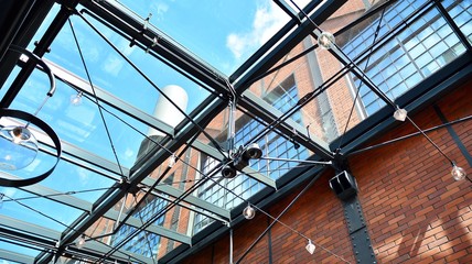 Glass ceiling with lamps in revitalized building.