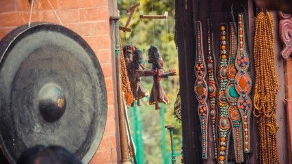 Colourful bead and puppet hanging on the wall