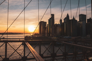 Sunset with views from the Brooklyn Bridge with the New York Skyline and the Hudson River