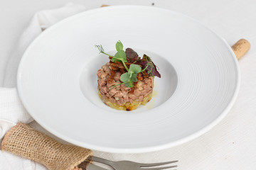 duck tartare on whitw plate white background