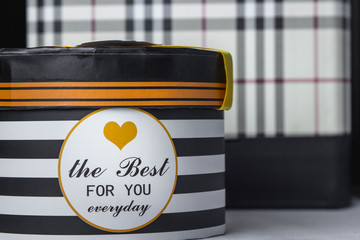 Gift concept. Gift box. In black and white stripes. On the box heart is drawn
