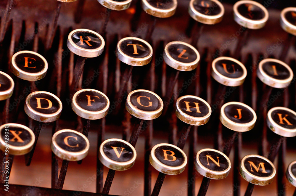 Fototapete detail of very old antique typewriter keyboard from first world war. low depth of field.