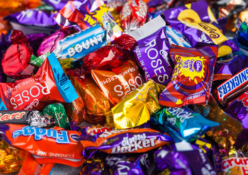 LONDON, UK - OCTOBER 10, 2019: Mix chocolate candies on white background. Quality Street, Celebrations, Roses and Heroes