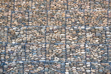 Fototapeta premium Mesh and stone fence, gabion wall for use in civil engineering, road building, military applications and landscaping