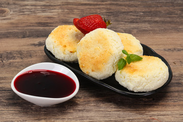 Curd pancakes with jam and stravberry