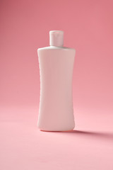 White bottle over pink background