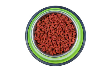 Dry food for cat or dog in a bowl. Pet food isolated on white background. Top view