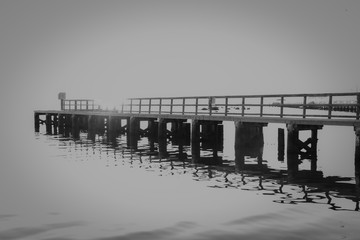 Black and White sunrise overexposed dock