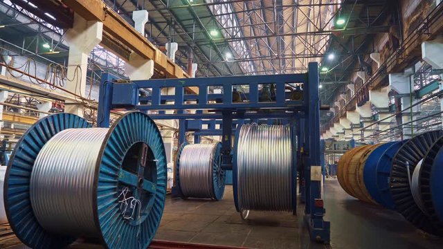 Cable factory. Metal, optical, copper, power wires are wound on huge coils. Products are used in the energy, transport, construction, engineering, nuclear, defense, oil and gas industries.