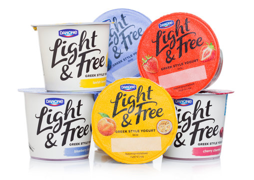 LONDON, UK - OCTOBER 10, 2019: Cups of Danone Light & Free greek style natural yogurt different taste on white background.
