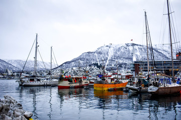 Boats in the harbour on the freezing polar circle, Tromso in Norway