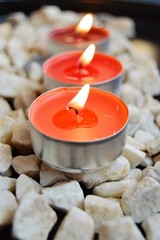 Three red candles on the stones