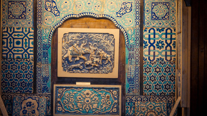 The engraved blue pattern on the wall