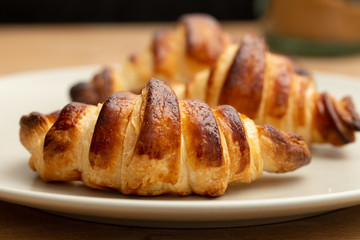 three freshly-baked croissants on a plate