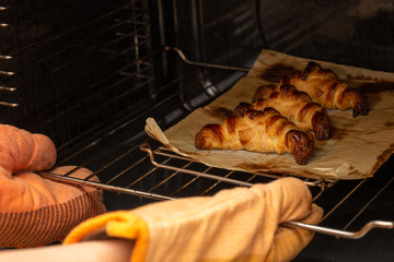 croissants being removed from the oven
