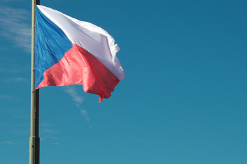 A lowered Czech flag flutters in the wind.