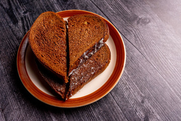 Buttered Rye Bread Toast in a Heart Shape on a Plate