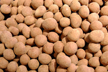 A pile of chocolate sweets as a background. Candy close-up.