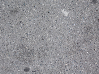 Texture of dusty dry asphalt on a sunny day.