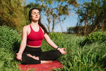 Young woman doing yoga meditation outdoors