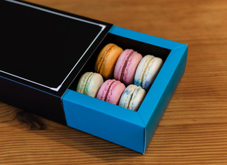 macaroni french cookies sweet and colorful, dessert in a box, on a light background