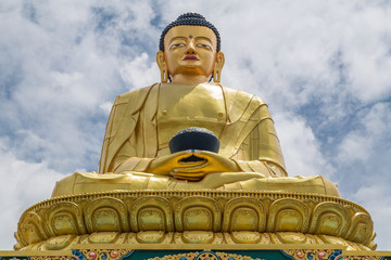 Fototapeta premium Big golden statue of the last historical Buddha, Shakyamuni (Siddhartha Gautama) in Buddha park, Swayambhunath area, Kathmandu, Nepal.