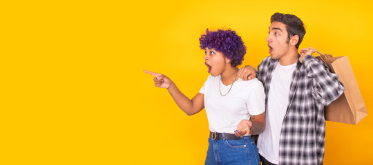 isolated young couple with shopping bags