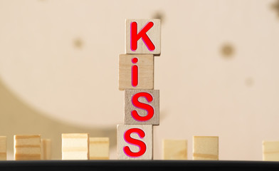 Isolated colored wood blocks, with the word kiss painted.