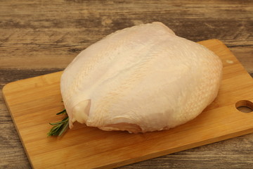 Raw whole chicken breast with skin