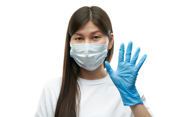 Young asian girl in medical mask and blue gloves pointing on five on white background isolated