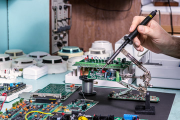 Technician repairing micro circuit devices electronic technology : hardware, protection sensors,...
